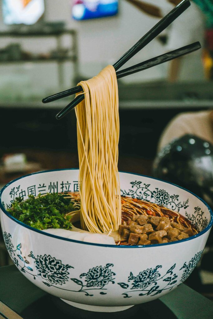 pexels photo 27054713 27054713 Tantalizing ramen noodles with meat and vegetables in a beautifully decorated bowl, featuring traditional Asian cuisine.